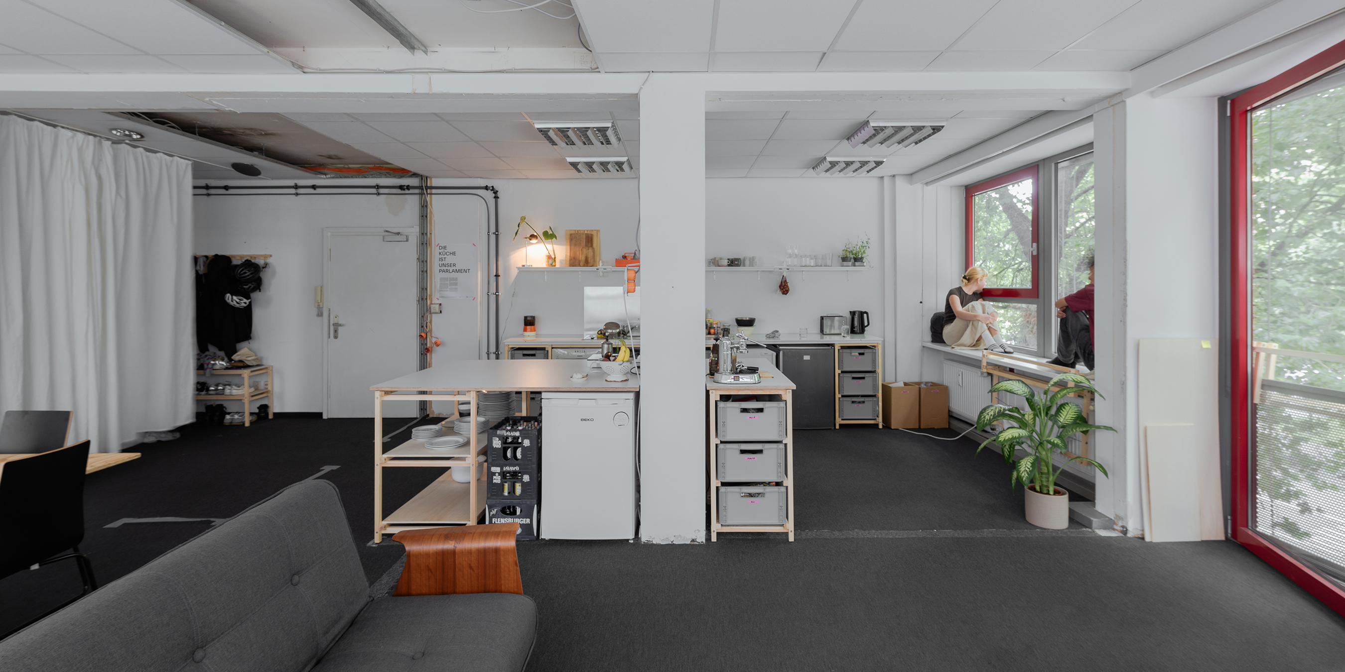 Shared kitchen and lounge in communal housing with social architecture.