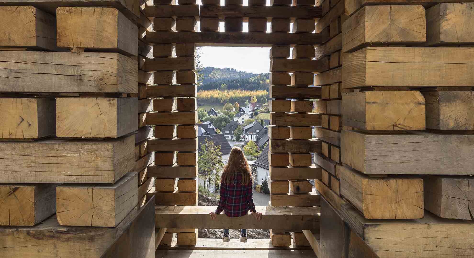 Wooden construction framing a scenic view, symbolizing how architecture supports conserving resources while connecting with nature.