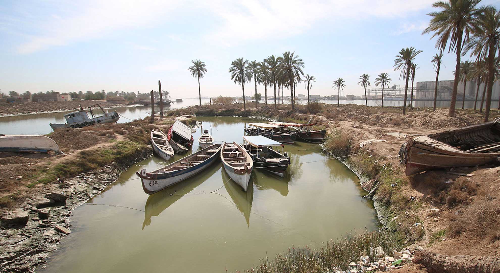 The dry climate creates pools of shallow, salty water along the River Shatt al-Arab in Basra. Photo © Nisan Al Jazairi